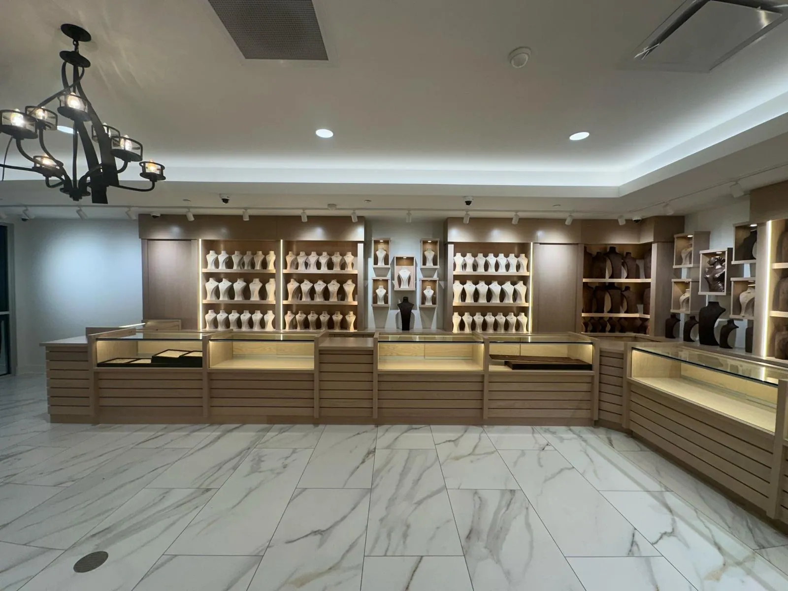 Custom oak jewelry showroom casework with backlit display shelving by AT Cabinetry